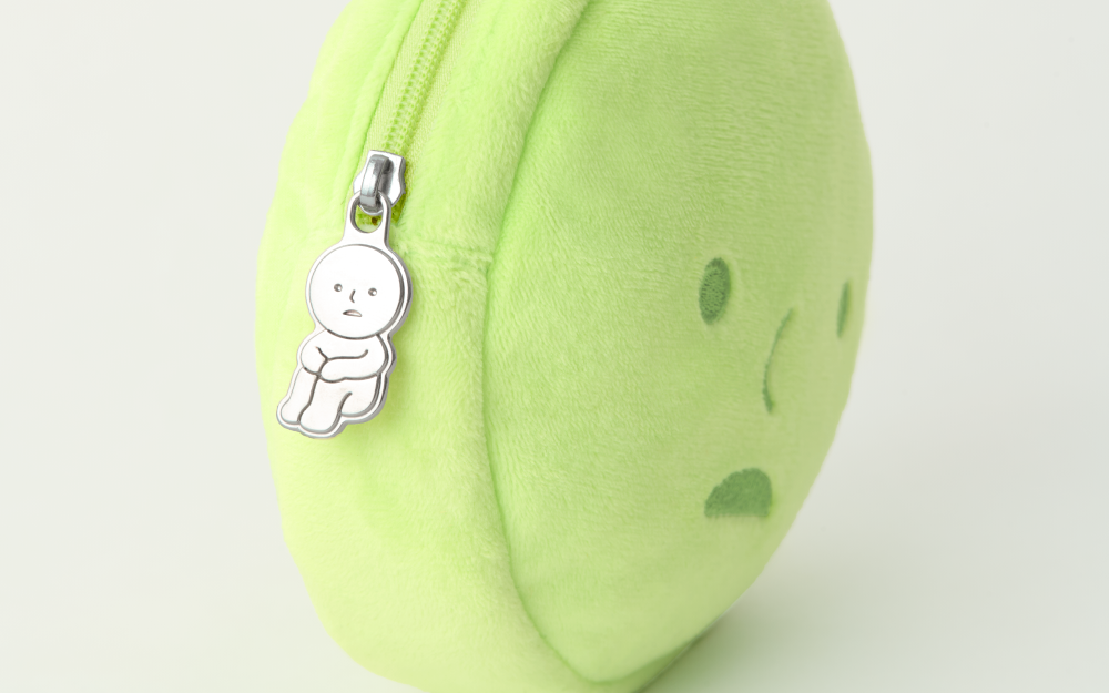 SMISKI Cushion Pouch - Preorder; lime-green plush with embroidered face, zipper, silver SMISKI Hugging Knees charm, ideal for small accessories.