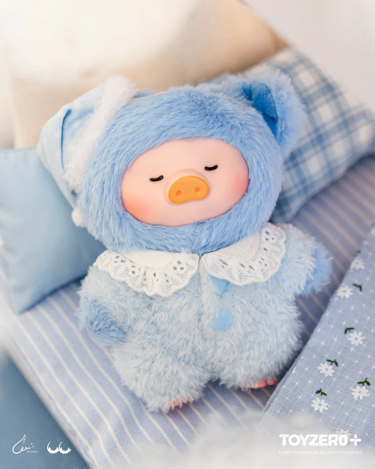 LuLu the Piggy plush keychain in a light-blue onesie, posed on a striped cushion, part of the Dreaming Wonderland Series blind box collection.