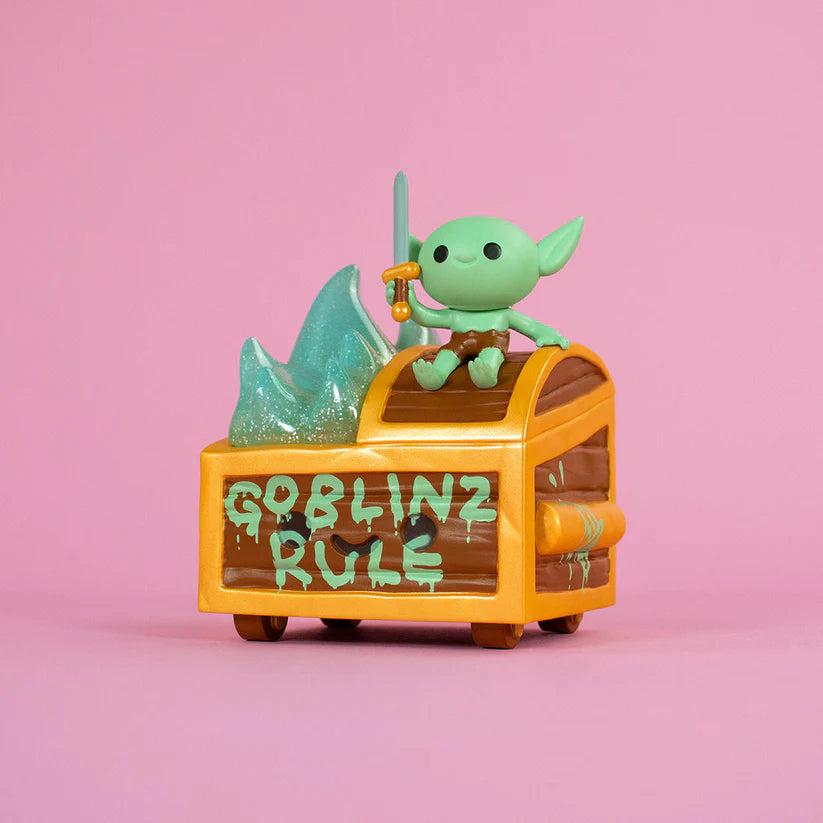 Wizard of Barge Dumpster Fire Vinyl Figure - Preorder: Goblin figurine atop treasure chest, holding sword and charm; features glittery slime detail.
