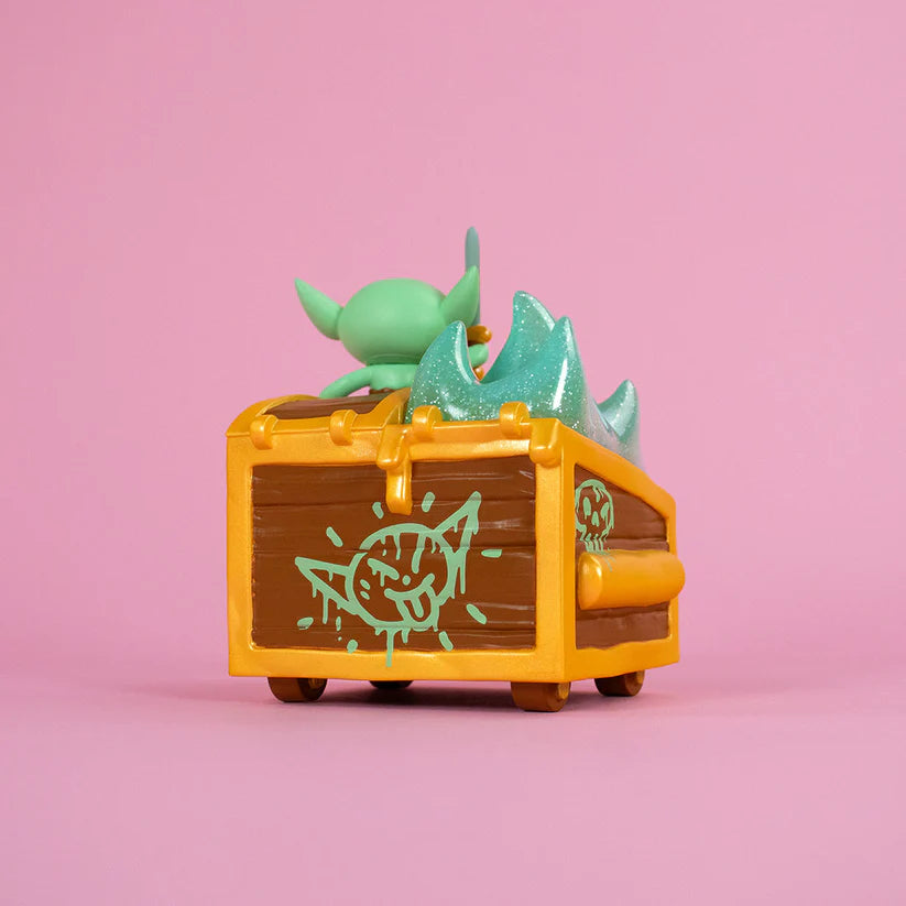 Wizard of Barge Dumpster Fire Vinyl Figure, featuring a goblin in a crate with a detachable sword, glittery slime, and cartoon face. Preorder for November 2025.
