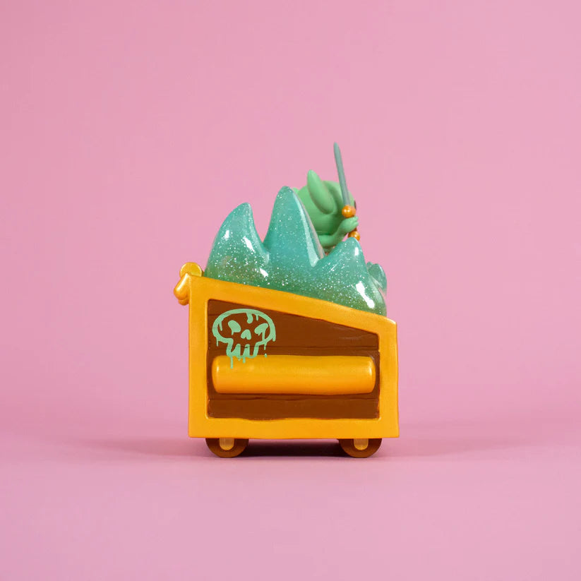 Wizard of Barge Dumpster Fire Vinyl Figure featuring a yellow-orange mine cart with green slime and a goblin holding a rod, set against a pink backdrop.