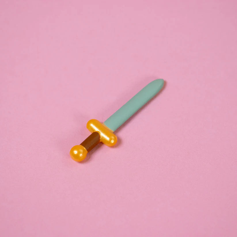 Wizard of Barge Dumpster Fire Vinyl Figure - Preorder: Detachable toy sword with teal blade, yellow hilt, brown grip, designed for the Goblin Party Dumpster Fire figure.