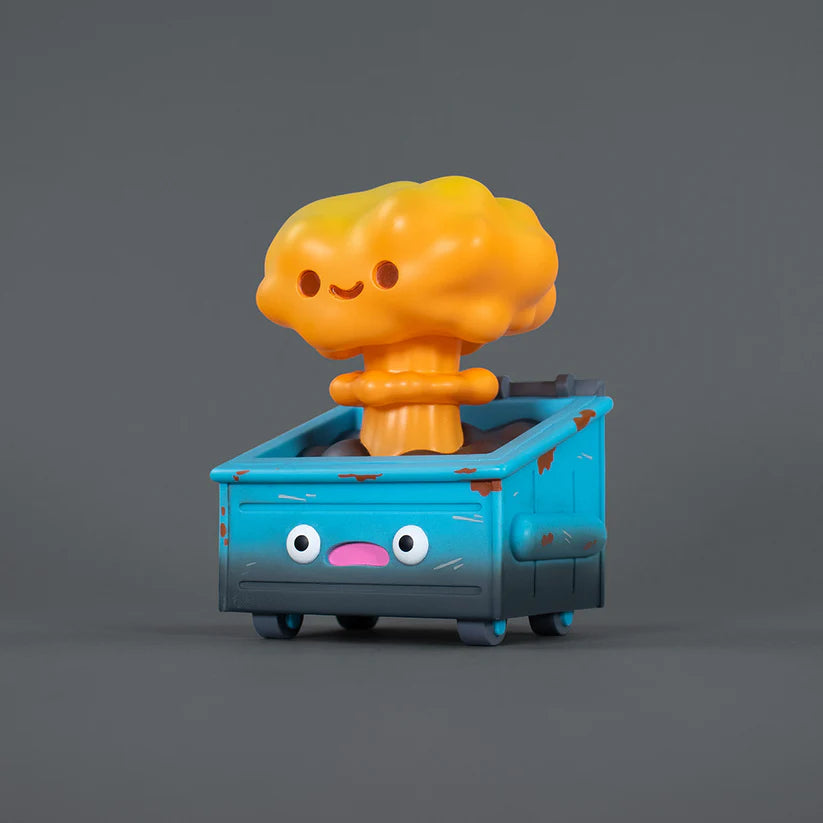 Nuclear Dumpster Fire - Preorder: A 3D toy of a weathered dumpster with cartoon eyes and a smiling mushroom-cloud explosion emerging, resembling a playful apocalyptic scene.