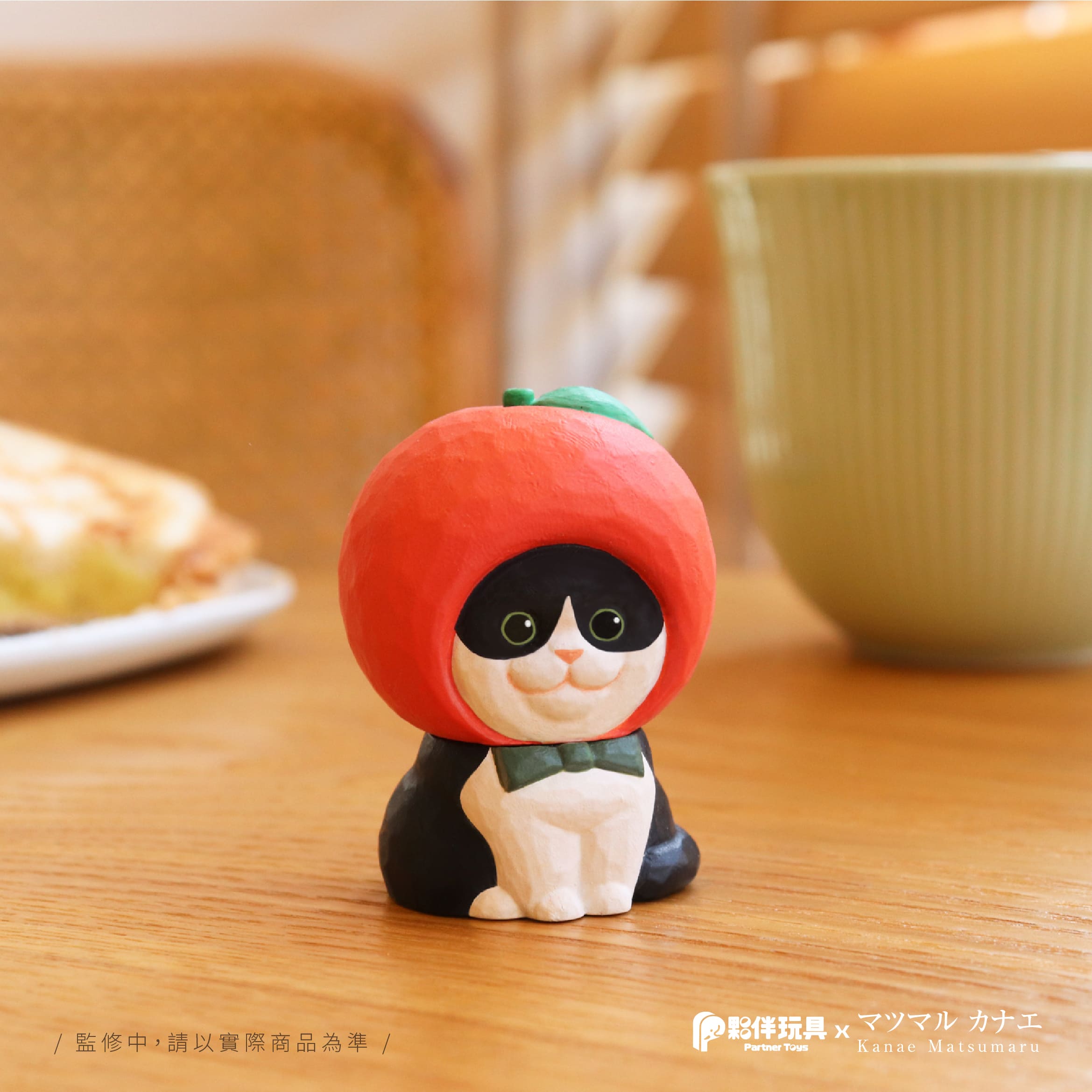 A small figurine of Matsu's cats with a hat on a table, part of a blind box series.