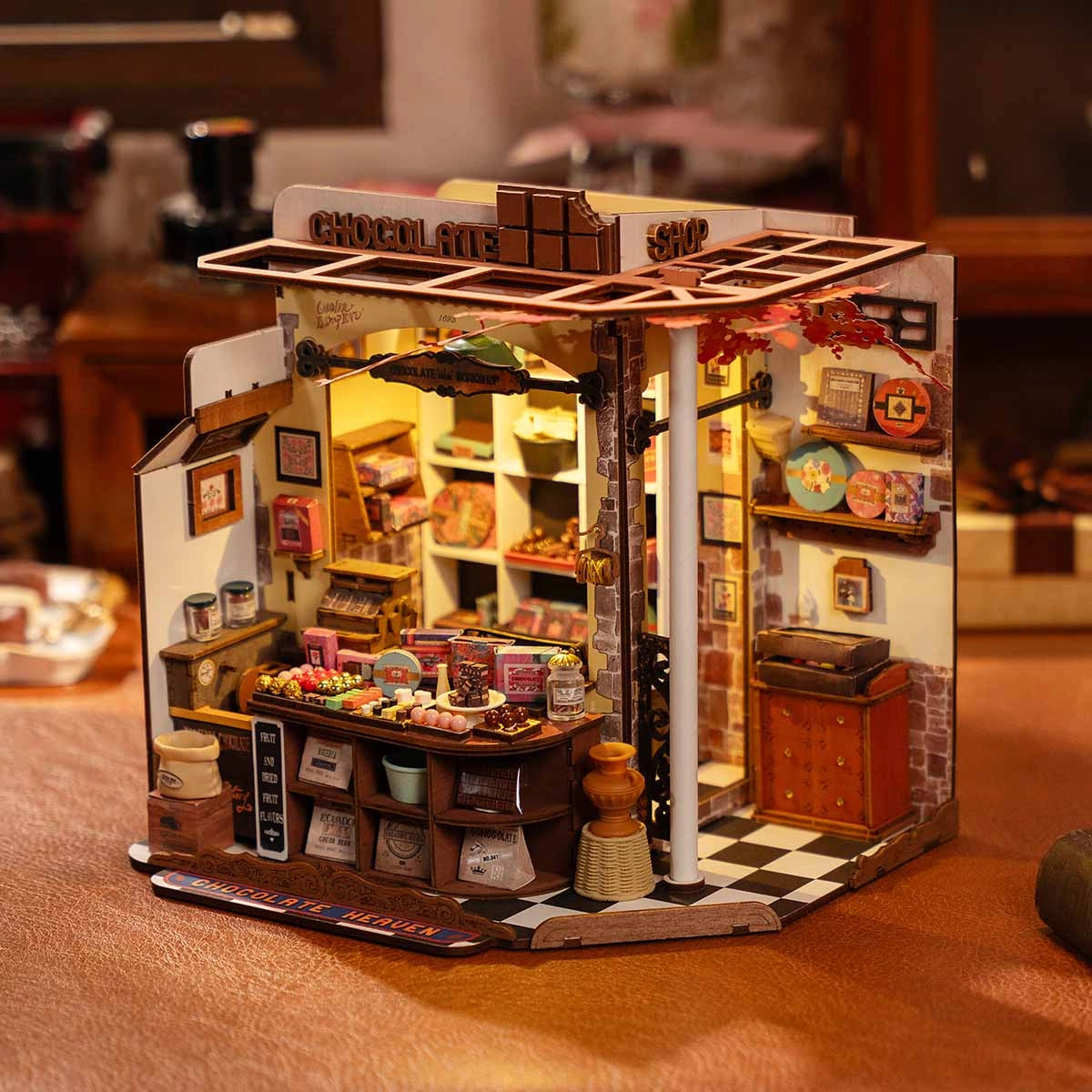 DG174 Henry's Chocolate Rolife DIY Miniature House with detailed chocolate shop diorama, featuring tiny shelves, candy jars, and a front display counter.