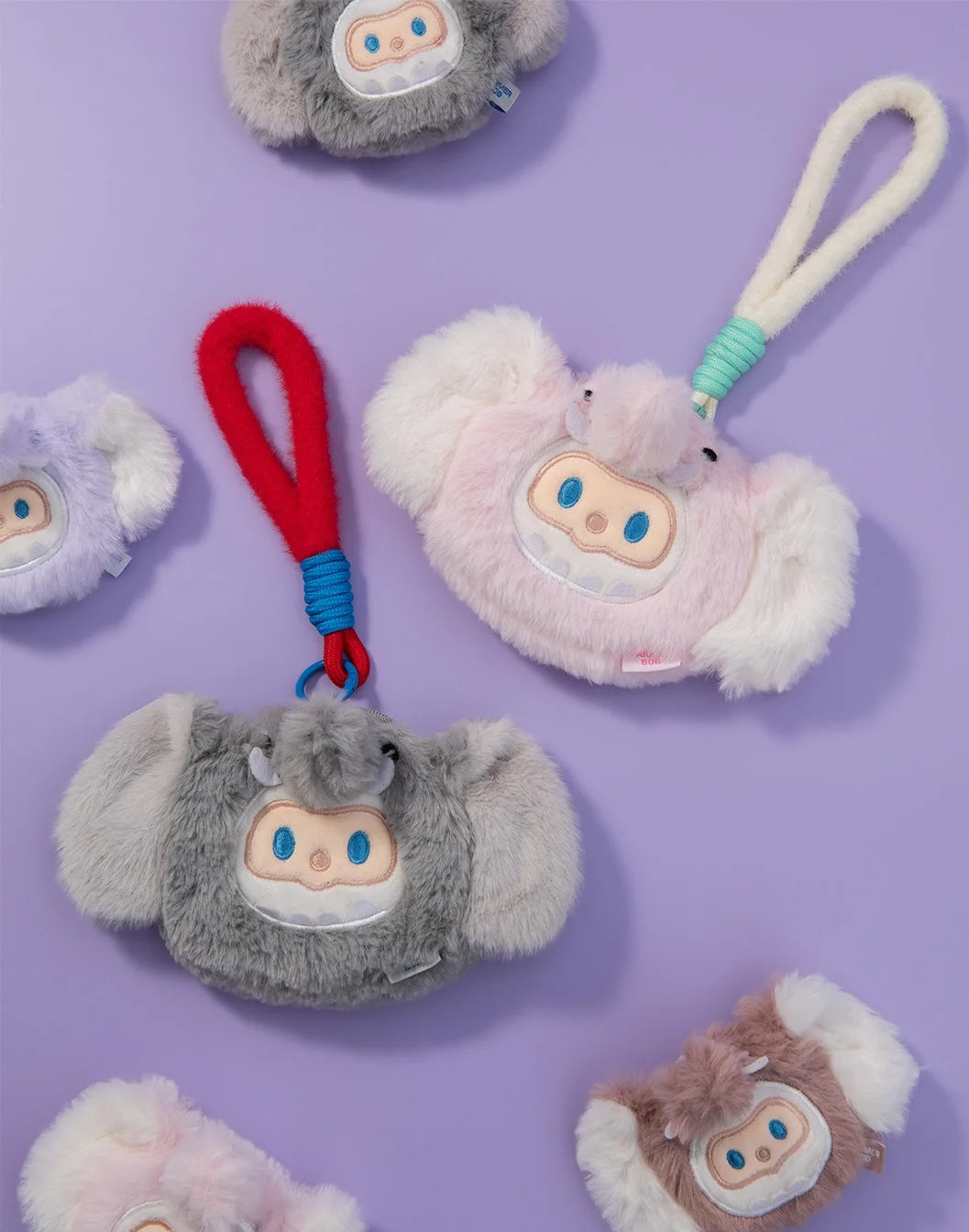 FINDING UNICORN FARMER BOB FURRY COIN PURSE features plush, half-moon creatures with floppy ears and a rope handle, perfect as unique keychains or accessories.