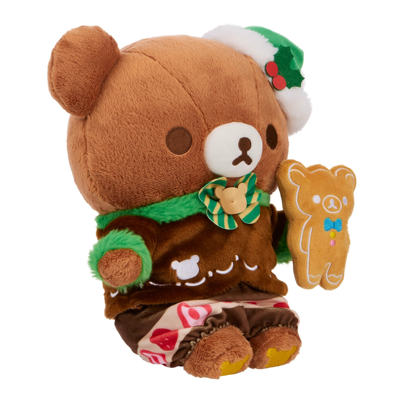 Chairo Holiday Cake Plush: A festive teddy bear in gingerbread attire with a Santa hat and holding a gingerbread-shaped bear cookie plush, measuring 11 inches.