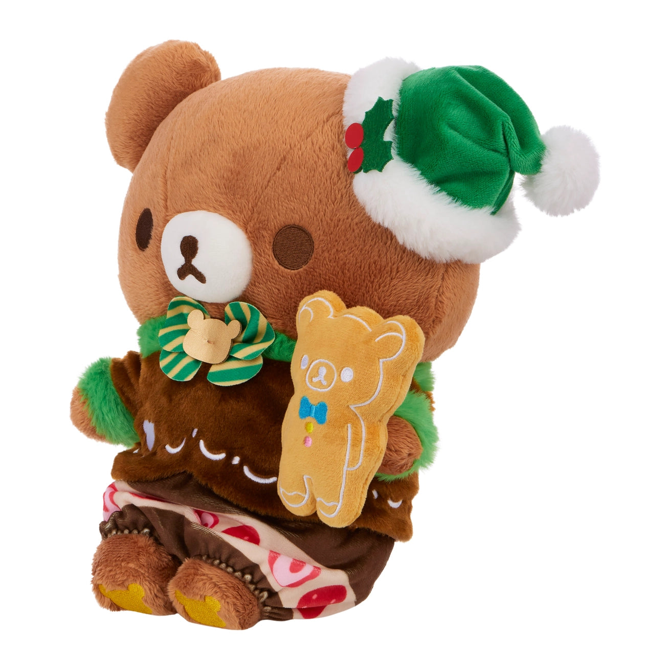 Chairo Holiday Cake Plush: A teddy bear in a gingerbread outfit with a green Santa hat, holding a gingerbread-man plush cookie, perfect for holiday-themed collections.