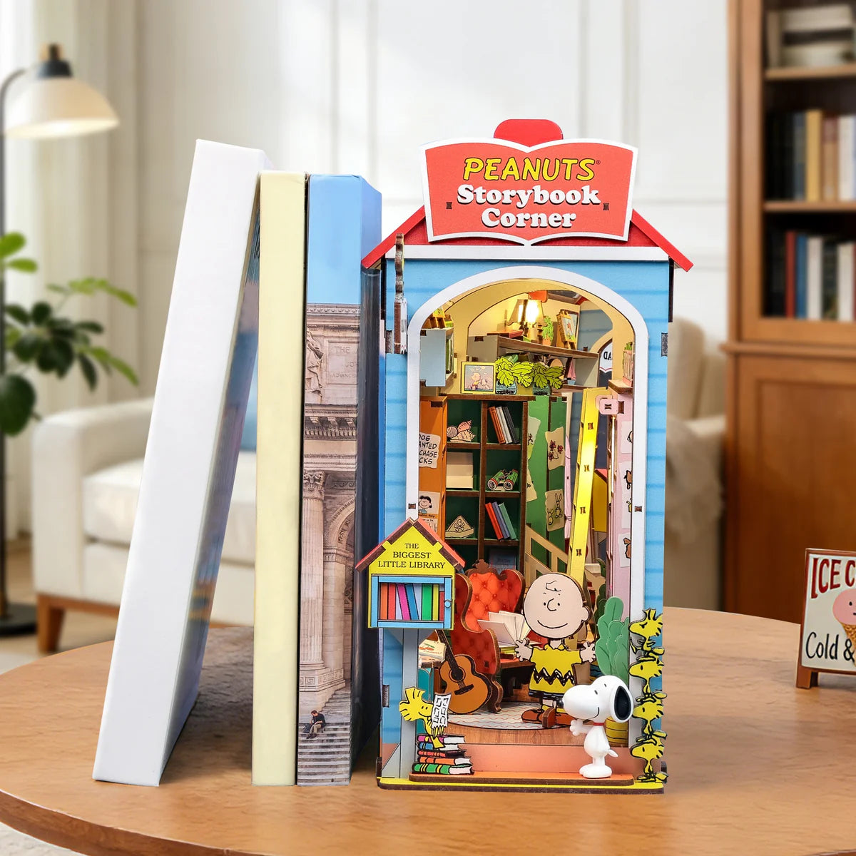 Peanuts Storybook Corner Booknook: A detailed diorama bookend featuring Charlie Brown, Snoopy, and Woodstocks, complete with tiny shelves, books, and a Biggest Little Library box.