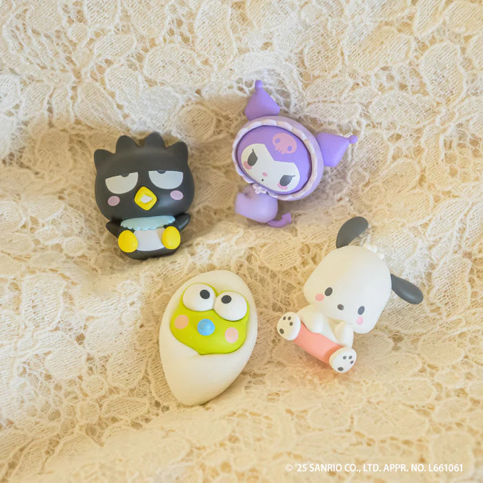 Sanrio Characters Baby Room Collection 2nd Edition Gacha Series featuring Badtz-Maru, Kuromi, Pochacco, and Keroppi figures arranged on lace.