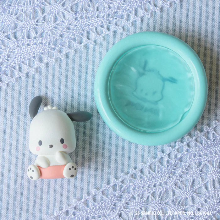 Sanrio Characters Baby Room Collection 2nd Edition Gacha Series featuring a Pochacco figure with an aqua ink pad on a striped background.