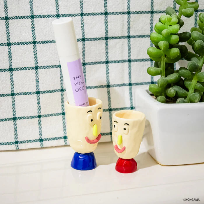 HONGAMA miniature collection Gacha Series: Two ceramic face cups, one holds a lip balm, accompanied by a succulent in a white pot.