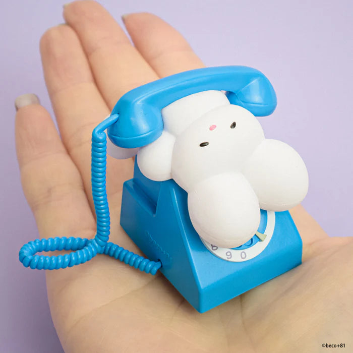 Tiny novelty rotary-style toy phone with a cute character, part of the beco+81 Art Emotional Collection Gacha Series, displayed on a hand.