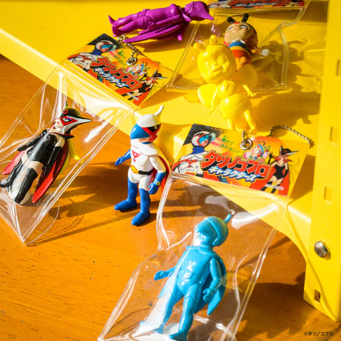 Tatsunoko Productions Characters Ball Chain Mascot Gacha Series featuring sofubi key-chains of classic characters, including Neo-Human Casshern and Hurricane Polymar, on a yellow display.