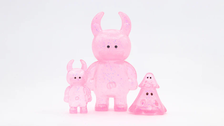UAMOU CLEAR PINK GLITTER: Three translucent pink vinyl figures with glitter, featuring horned and ghost shapes, black dot eyes; art toys by Strangecat Toys.