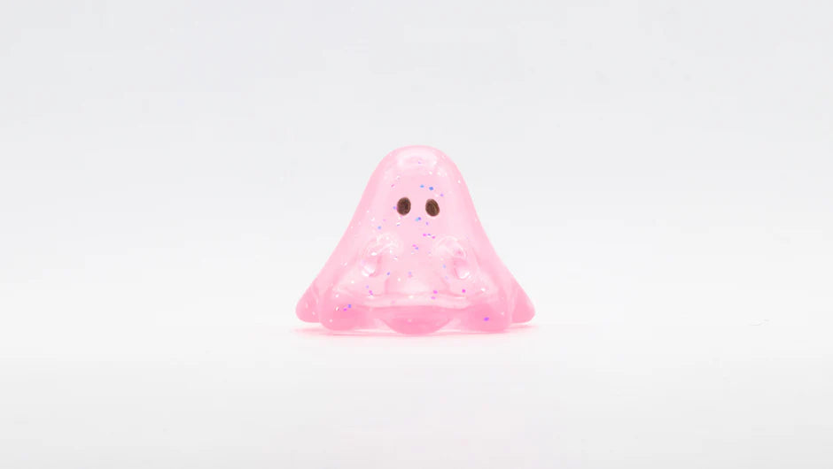 BOO CLEAR PINK GLITTER: A 2cm soft vinyl figure with a playful blob shape, glittery pink translucence, and dark eyes, embodying Strangecat Toys' whimsical art toy style.