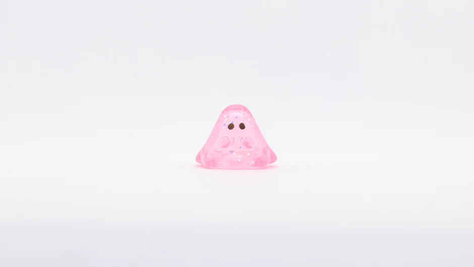 MINI BOO CLEAR PINK GLITTER: A 1cm, pink, translucent blob-shaped figure with simple eyes, resembling a cute cartoon ghost. Made of soft vinyl in Japan.