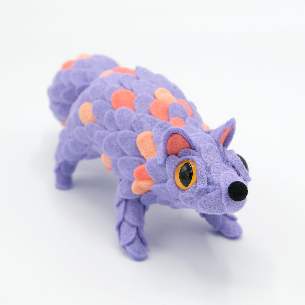Adorable Oracle plush by Horrible Adorables x Faunwood, featuring lavender felt scales, yellow eyes, and a unique design, part of the ORACLE Group Show.