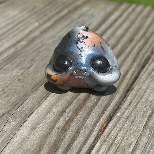 Little Shit Bigger Deal - Beasties Bites by Dear Beasties x Trash Panda, a 2.5 ocarina-shaped toy on a wood surface, capturing whimsical animal-inspired artistry.