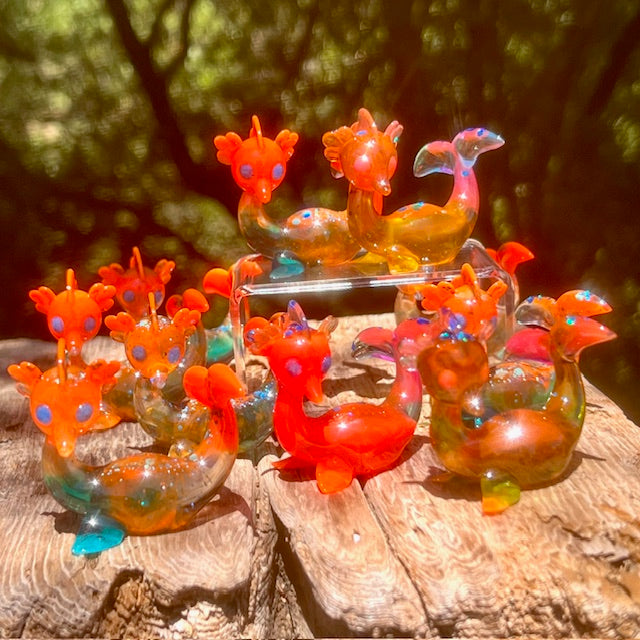 Little Shit Bigger Deal - Beach Day Bessie’s by Leecifer x Horrible Adorables, resin and mixed media glass animal sculptures on wood surface, edition of 10.