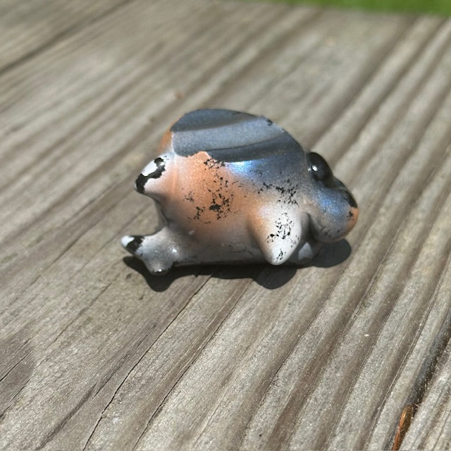 Little Shit Bigger Deal - Beasties Bites by Dear Beasties x Trash Panda: a 2.5 ceramic frog figurine displayed on a wood surface.