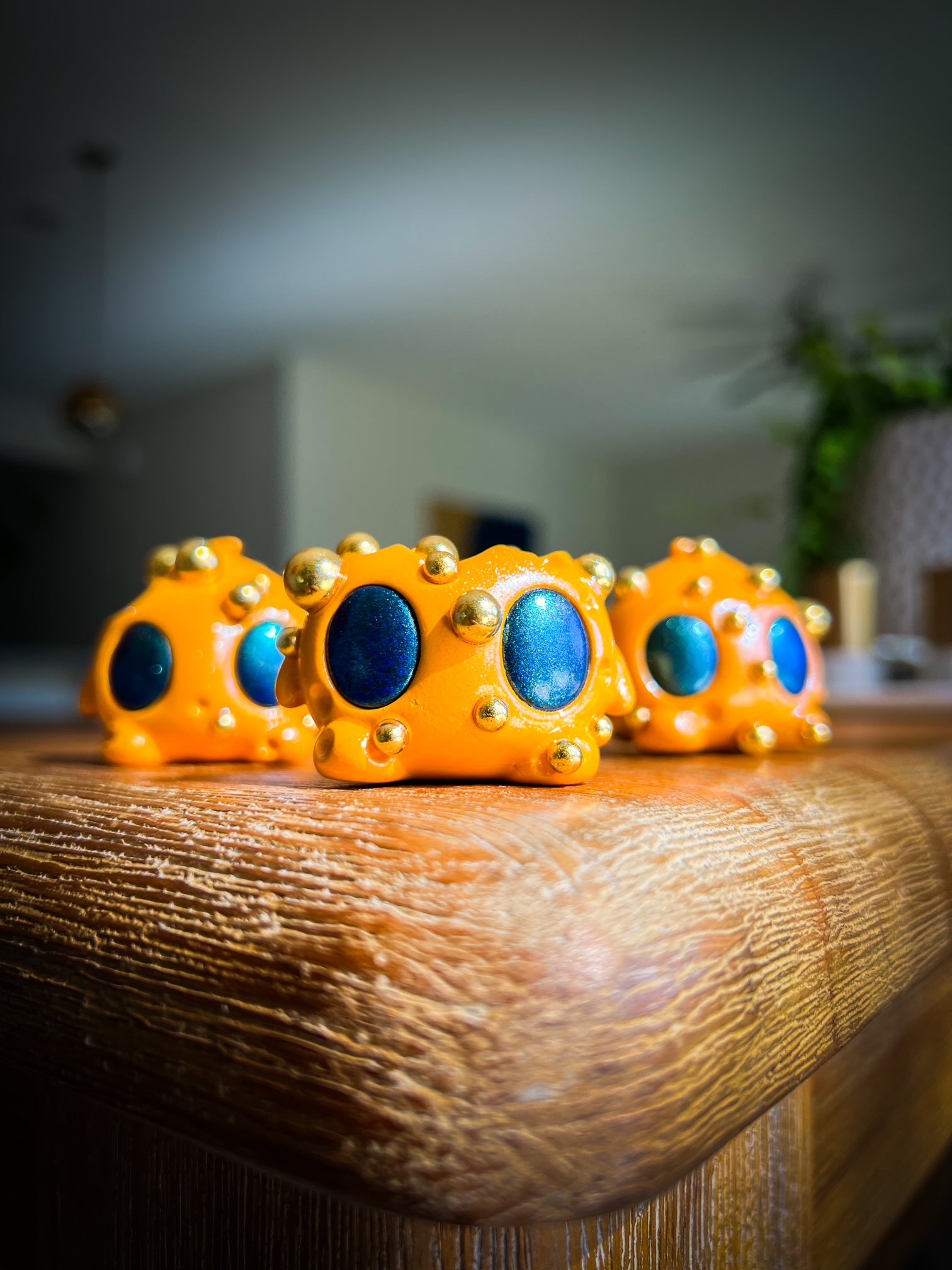 Bite Me - Bites by Mecha Panda: A whimsical mixed media art toy set featuring small, intricately detailed yellow objects with blue stones, showcasing unique character design.