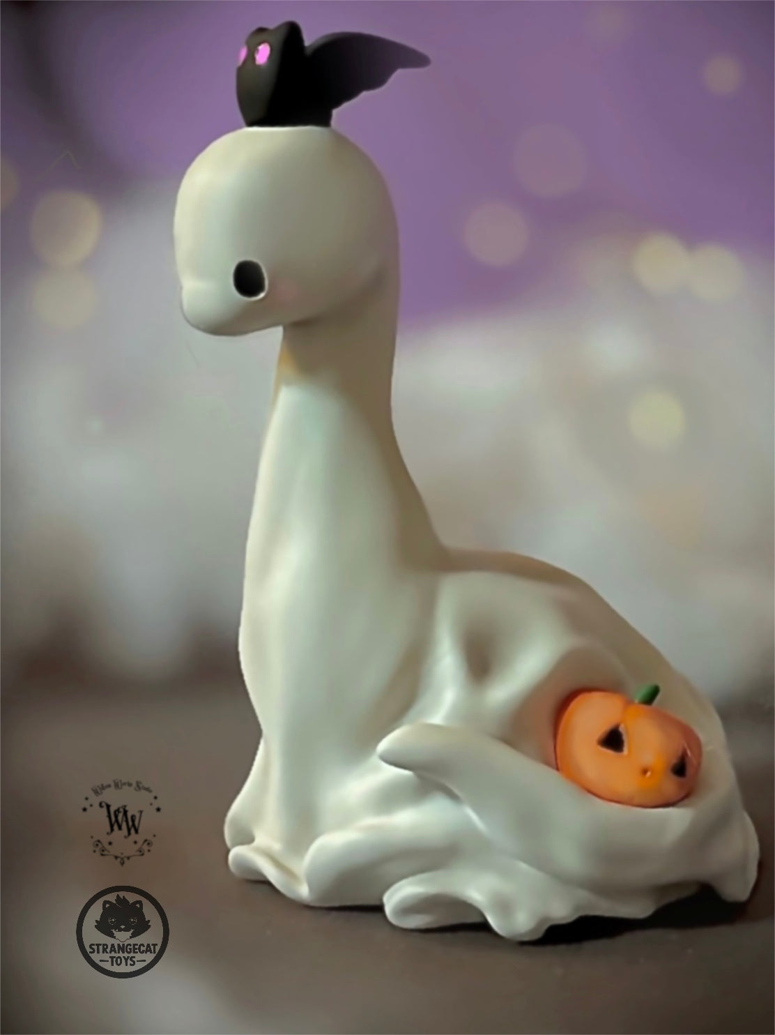 Ghost Dino by Willow Works: A 4-inch resin figurine of a ghost with a bat on its head and a jack-o’-lantern at its base.