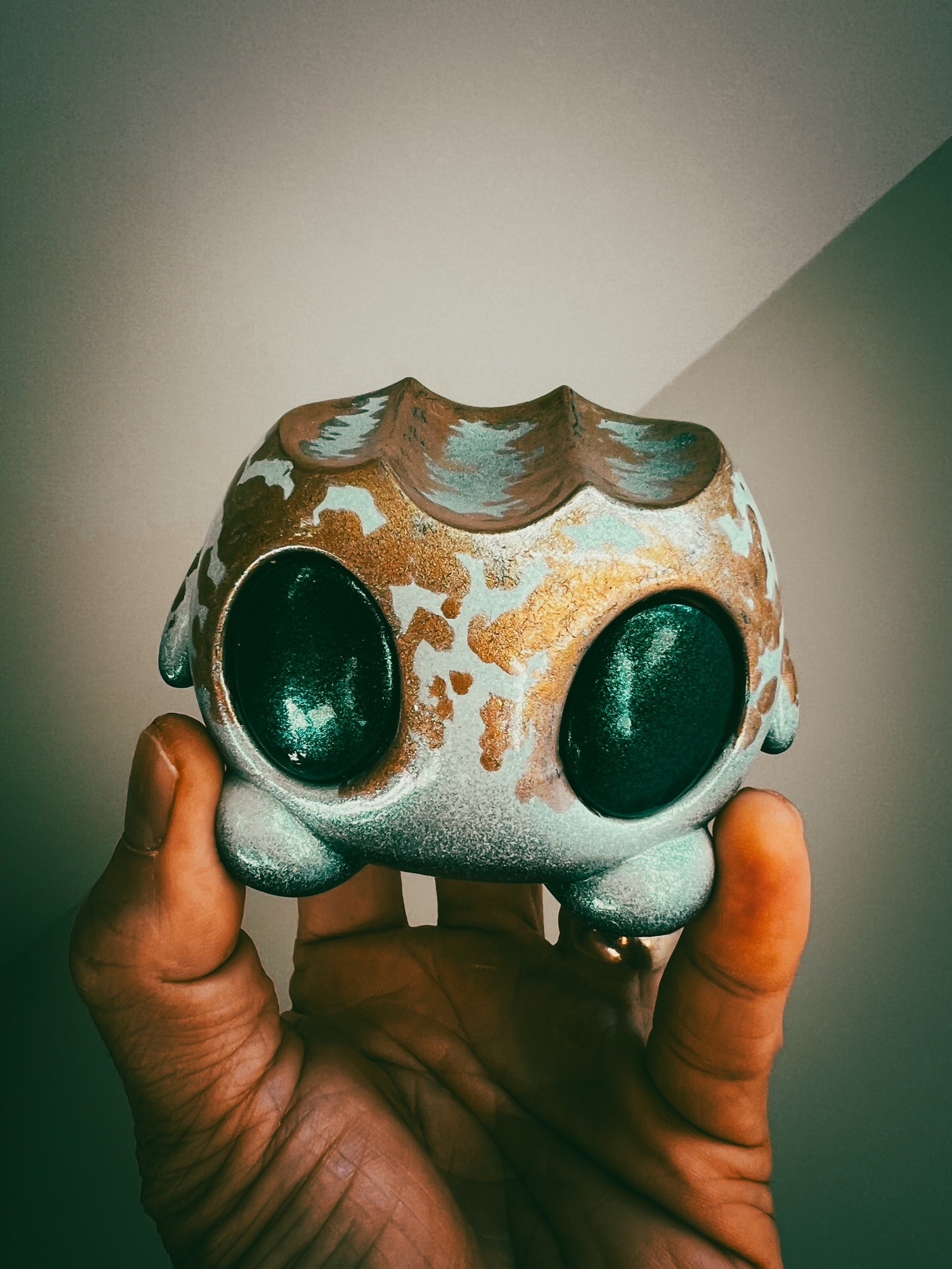 Hand holding the art toy Bite Me - Bites by Mecha Panda, an original character by Trash Panda, showcasing its unique mixed medium design.