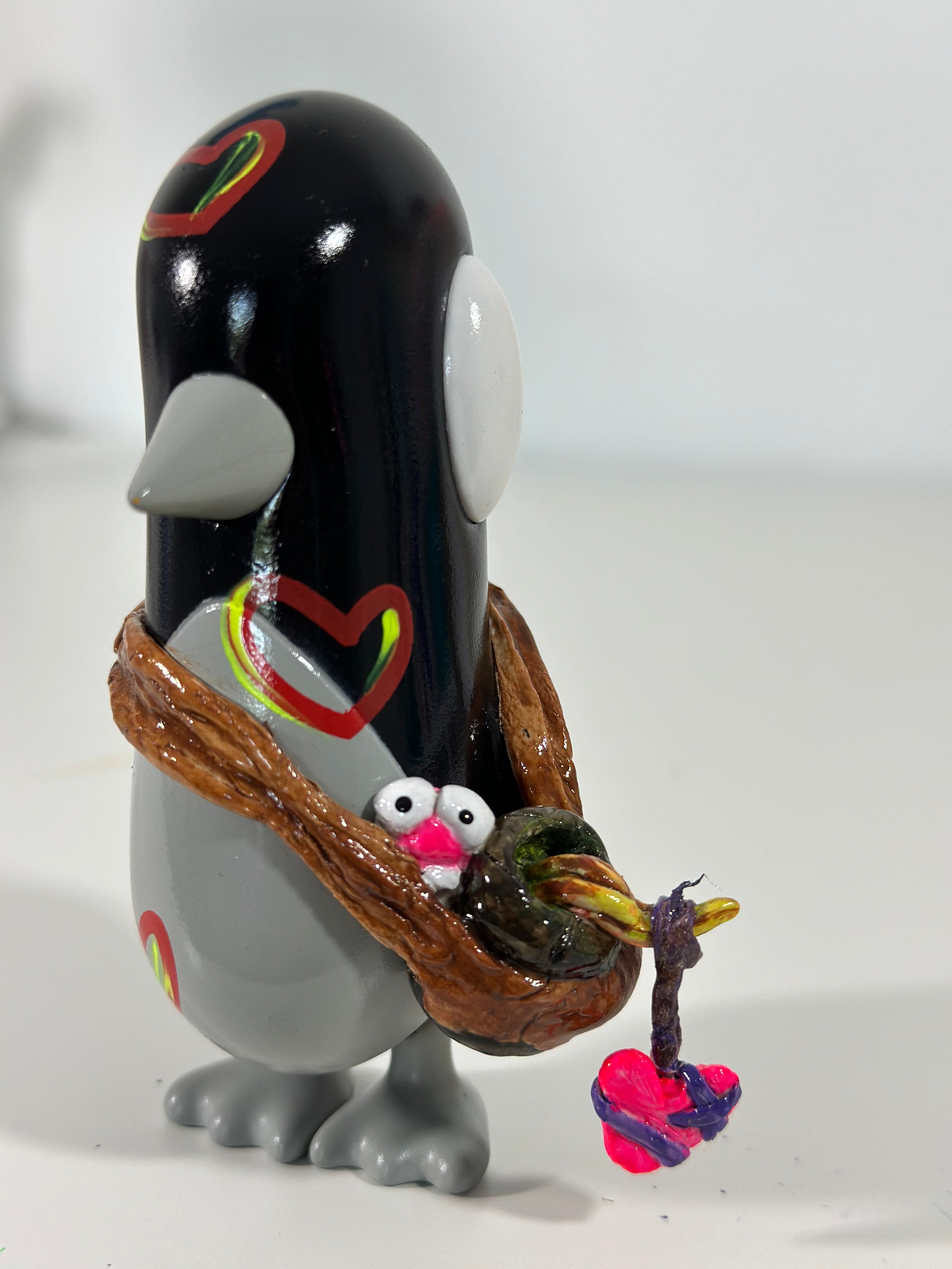 The Waddle Show - A buddies journey by DxE Studios, features a toy penguin holding a bird, highlighting the original character by Chris RWK.