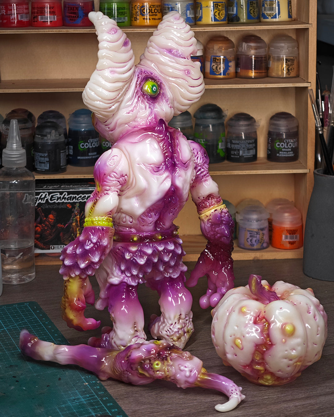 NPK · Poison Veil Ver. & Jack o’ Lantern III figures, in-progress paintwork, amidst a hobbyist's setup with paints, brushes, and accessories. Preorder at Strangecat Toys.