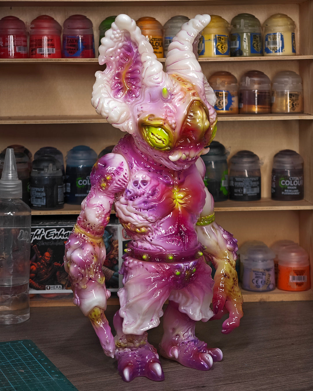 Custom-painted vinyl figure, NPK · Poison Veil Ver. & Jack o’ Lantern III, displayed on a workbench with paint pots and tools. Available for preorder at Strangecat Toys.