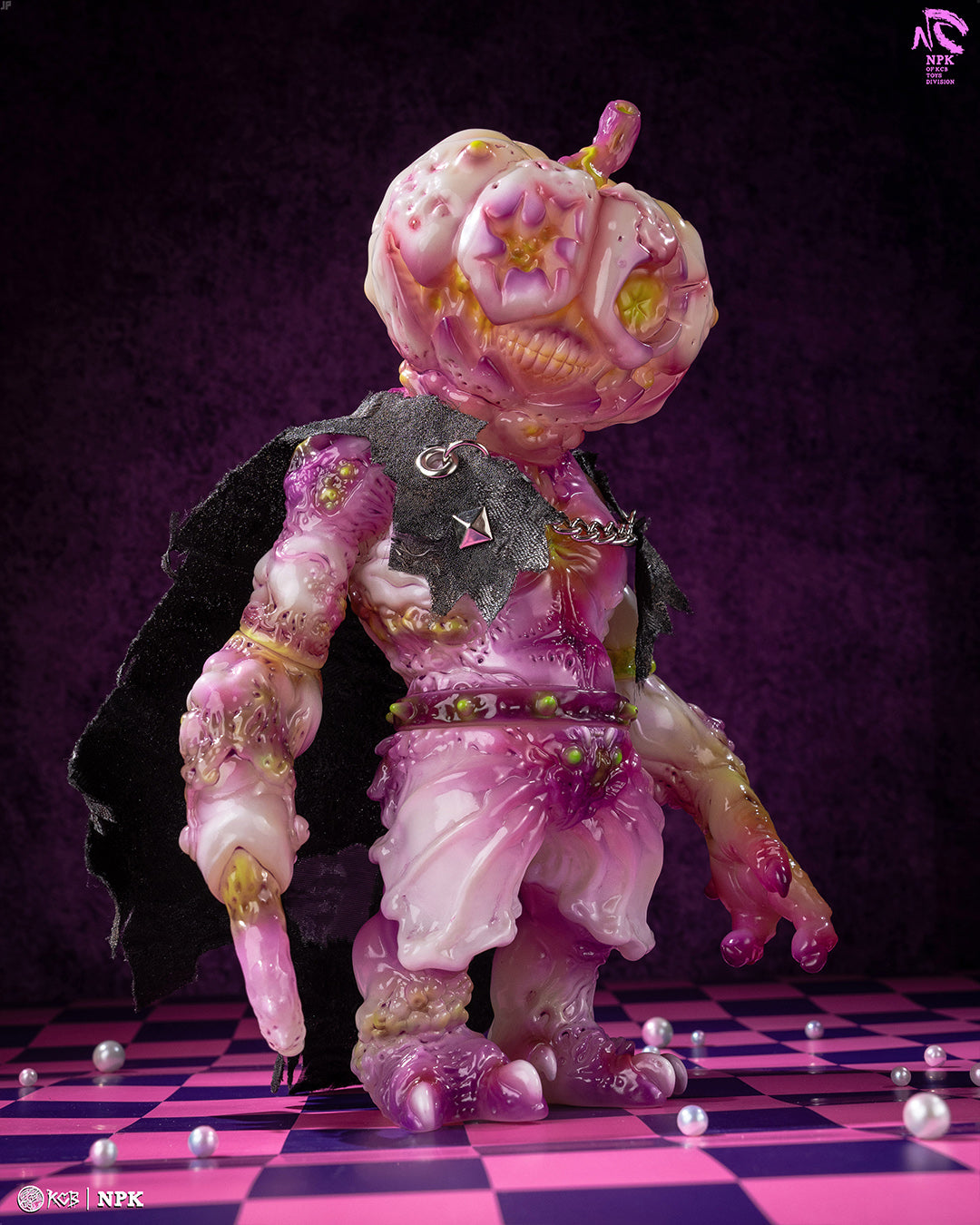 Designer toy NPK · Poison Veil Ver. & Jack o’ Lantern III features a gooey pumpkin creature with a black cape, on a checkerboard base, by KCB Toy.