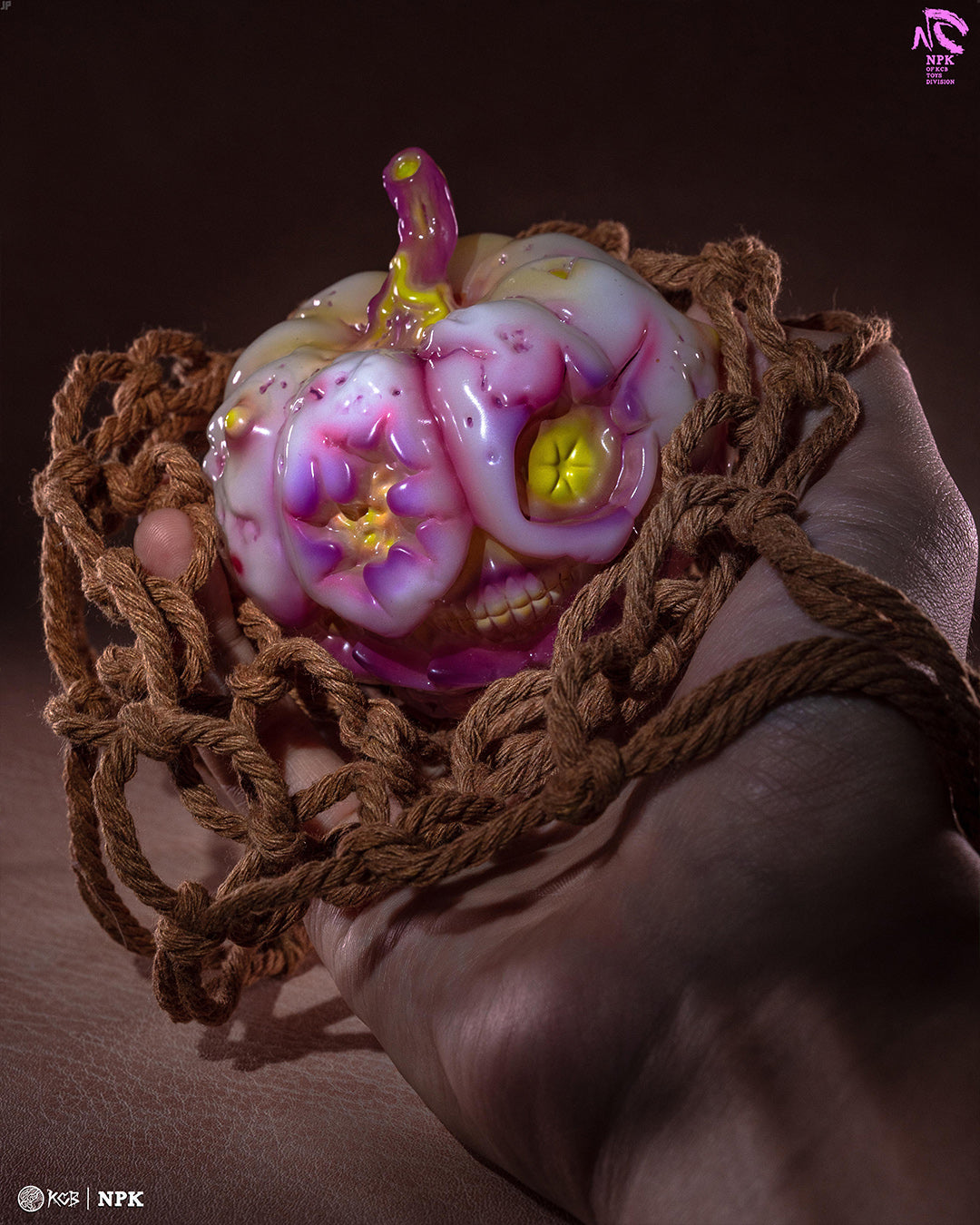 Hand holding netted NPK · Poison Veil Ver. & Jack o’ Lantern III, a 3.4-inch glossy resin art toy with sculptural pumpkin-skull design, logo visible.