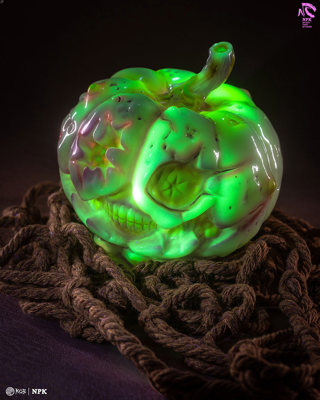 NPK · Poison Veil Ver. & Jack o’ Lantern III by KCB Toy: a skull-like pumpkin sculpture glowing green, set on thick rope, indicating a crafted art toy.