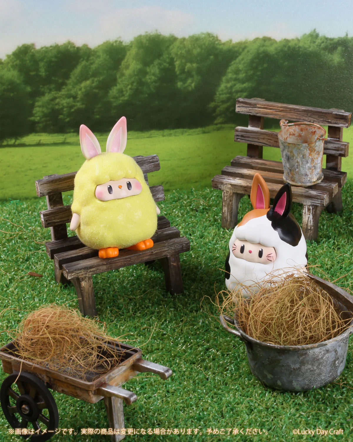BUNNY MAY FIGURE MASCOT Gacha Series: Miniature yellow chick and white sheep figures with bunny ears in a tabletop diorama featuring garden props.