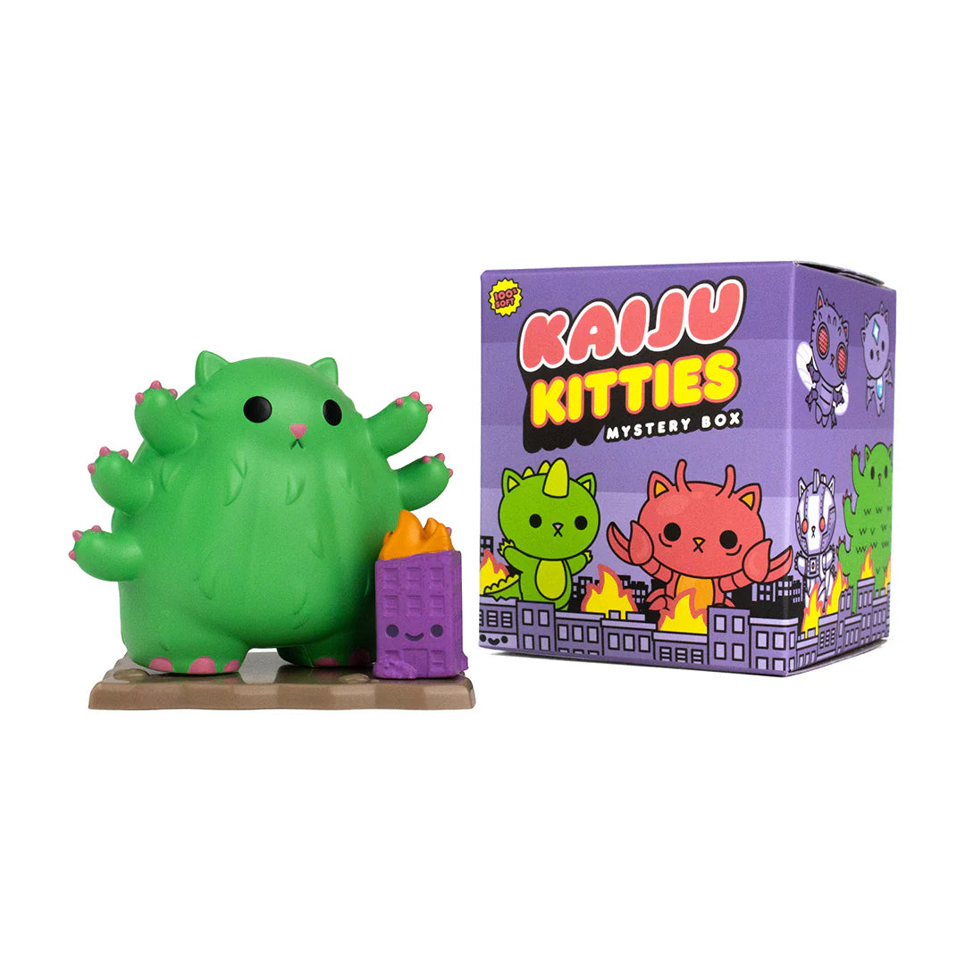 A blind box preorder: Kaiju Kitties Mystery Box Series 1 by 100% Soft. Toy figurine of green monster cat with tank accessory, cartoon cat box art.