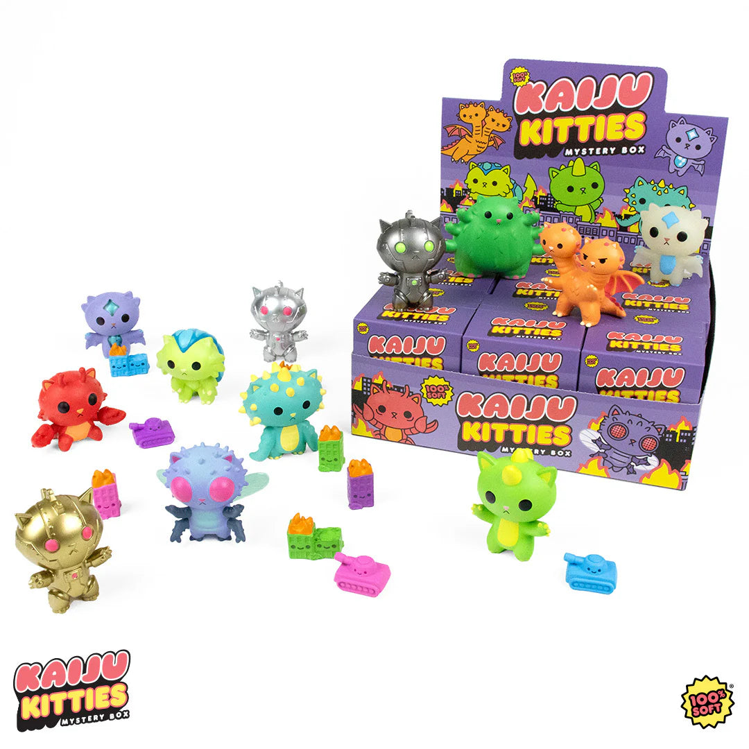 A group of cute toy animals, including a red, blue, green, gold, and silver toy, part of the Kaiju Kitties Mystery Box Series 1 by 100% Soft at Strangecat Toys.