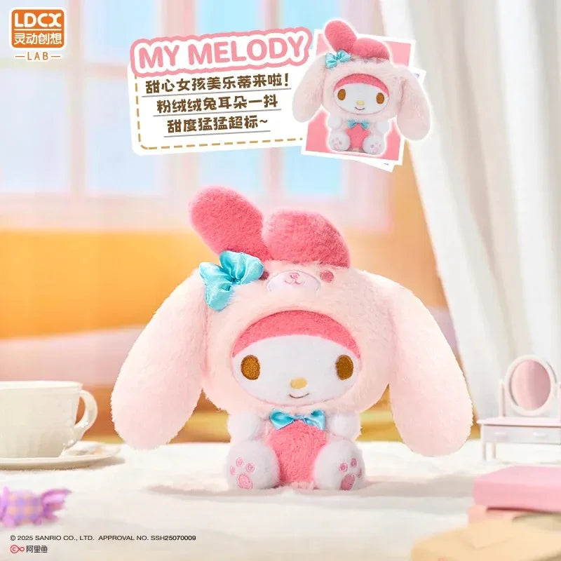 Overjoyed - Sanrio Family Plush Blind Box: My Melody plush in pink bunny-ear hood with blue bows, styled in a cozy setting. Preorder for November 2025 shipping.