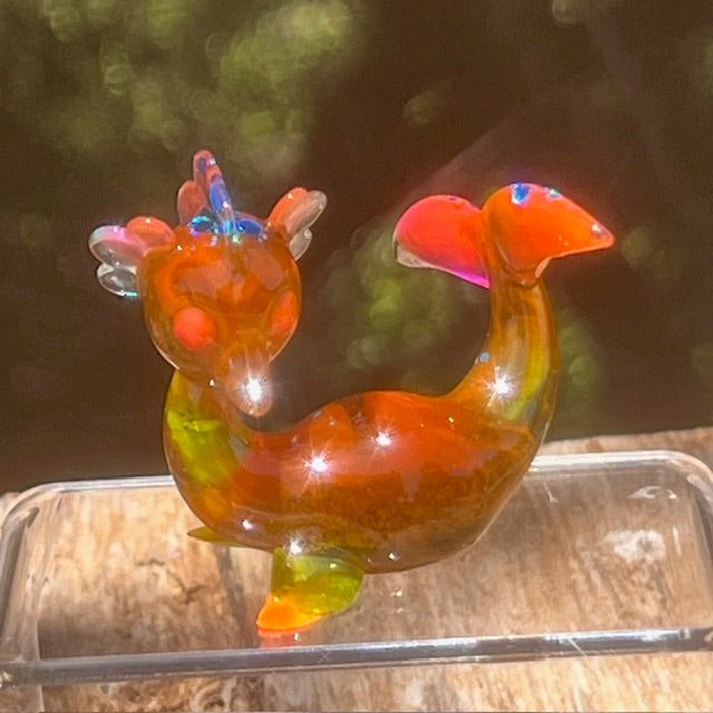 Little Shit Bigger Deal - Beach Day Bessie’s by Leecifer x Horrible Adorables: glass dragon figurine atop a glass container, showcasing unique resin craftsmanship.