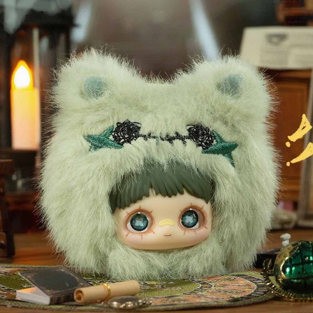MayMei Crazy Circus Series Plush Keychain Blind Box: Doll head in animal-ear hood, surrounded by trinkets, offering a whimsical, collectible surprise from Strangecat Toys.