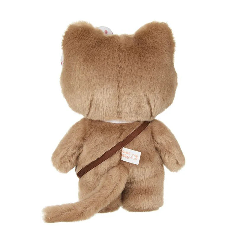 Back view of a small plush toy, Hello Kitty x Monchhichi HK as MCC Gingham Check, with a satchel strap over its shoulder, showcasing cat-like features.