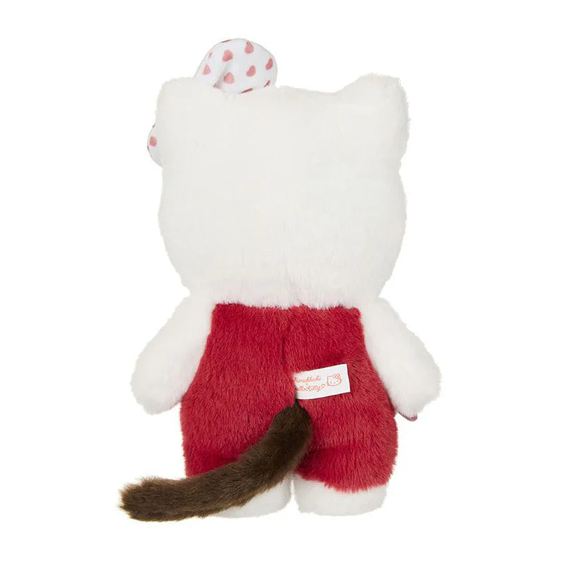Hello Kitty x Monchhichi Gingham Check Plush featuring a plush cat toy in red overalls with a bow, showcasing its back and brown tail.