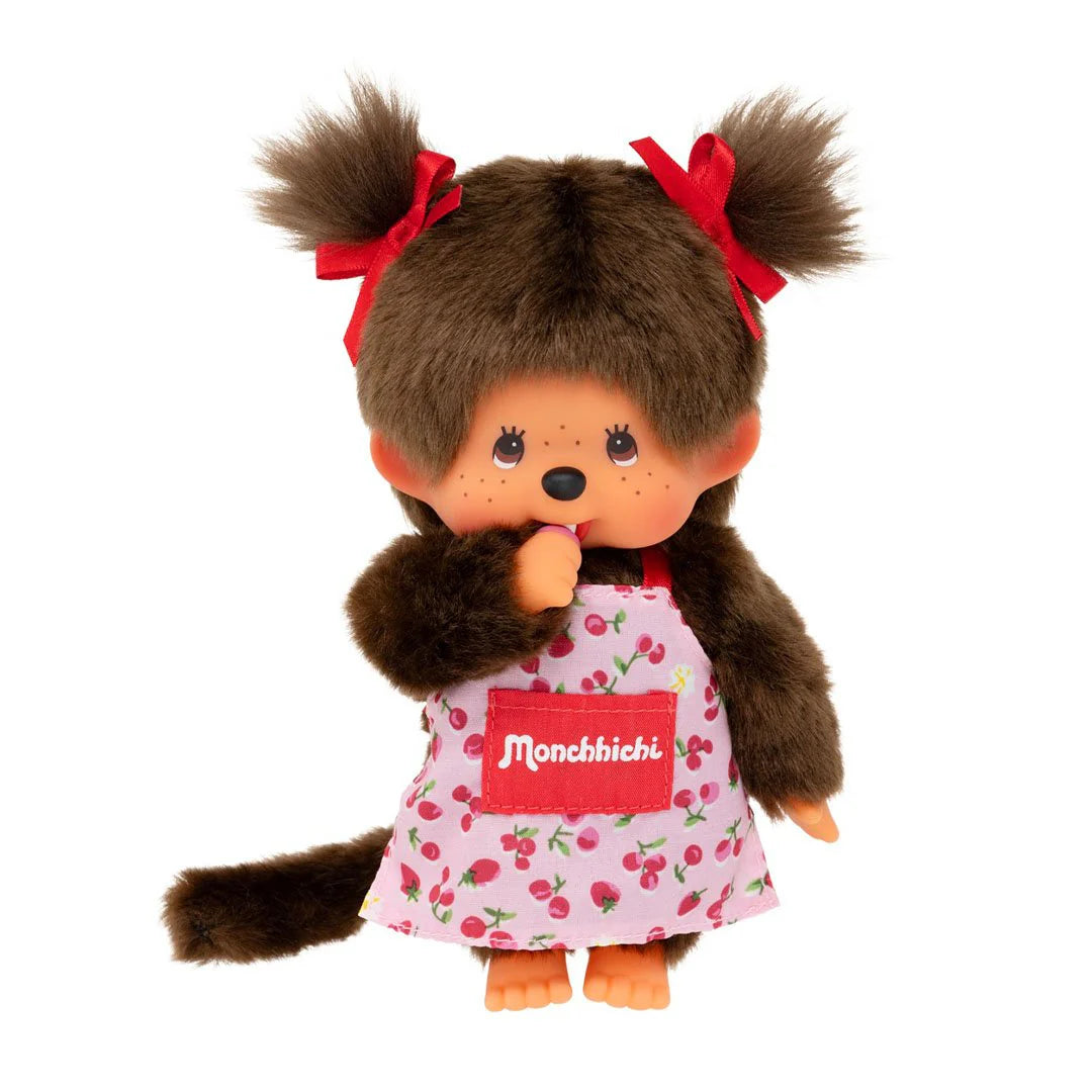 Monchhichi Girl - Flower Apron Plush Toy in a cherry-print dress with pigtails, thumb-sucking pose, perfect for collectors and Monchhichi enthusiasts.
