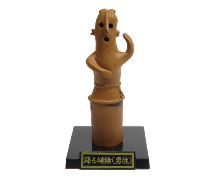 Small terracotta haniwa dancer figurine from the Kofun period, part of the Haniwa and Clay Figurines Gacha Series, mounted on a labeled black plinth.