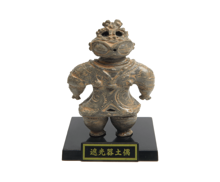 Jōmon-period shakōki-dogū figurine, part of Haniwa and clay figurines + earthenware and bronzeware Gacha Series, displayed with descriptive plaque.