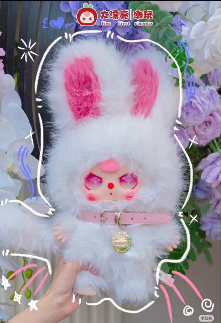 Migo Twins 400% plush doll in a fluffy bunny outfit with long ears, pink eyes, and a gold-tone charm, held before pastel flowers.
