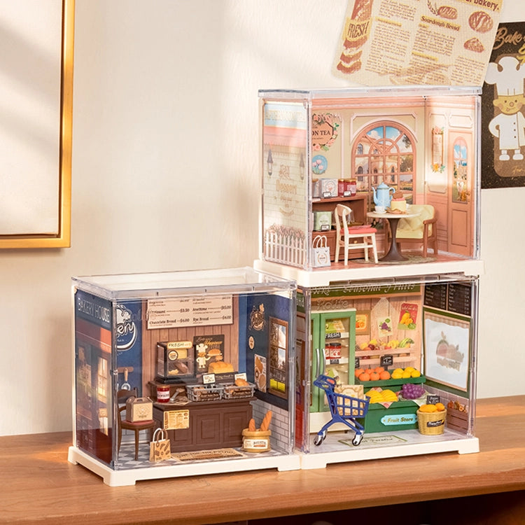 Rolife Mini Super Creator DIY Miniature House - Shop Series features dioramas of a café, bakery, and greengrocer in clear acrylic cubes, perfect for creative art toy enthusiasts.