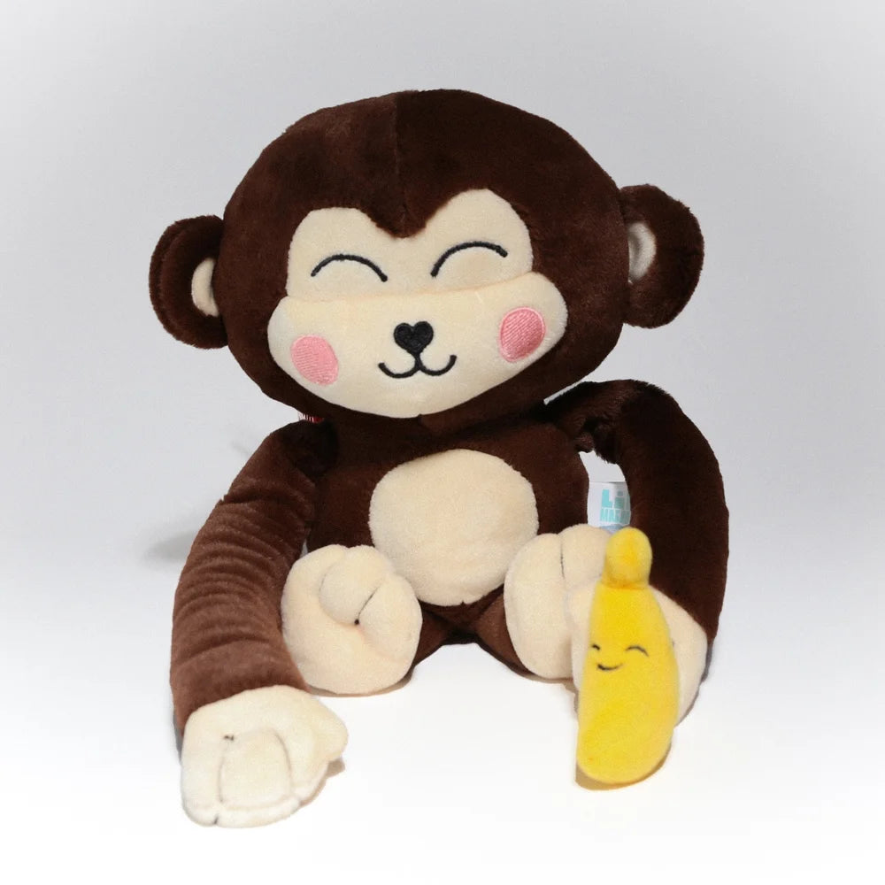 Monkay + Alligator Plush by Life Machine: A smiling plush monkey with floppy limbs holding a magnetic banana, merging predator-prey themes for harmony.
