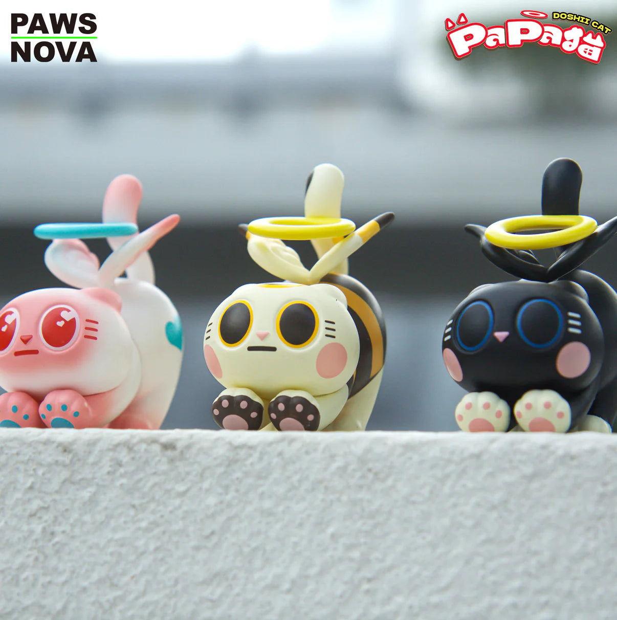 TROUBLE CREW PAPA CAT BLIND BOX showcases three vinyl cat figurines with halos and expressive features from Paws Nova’s Doshii Cat line.