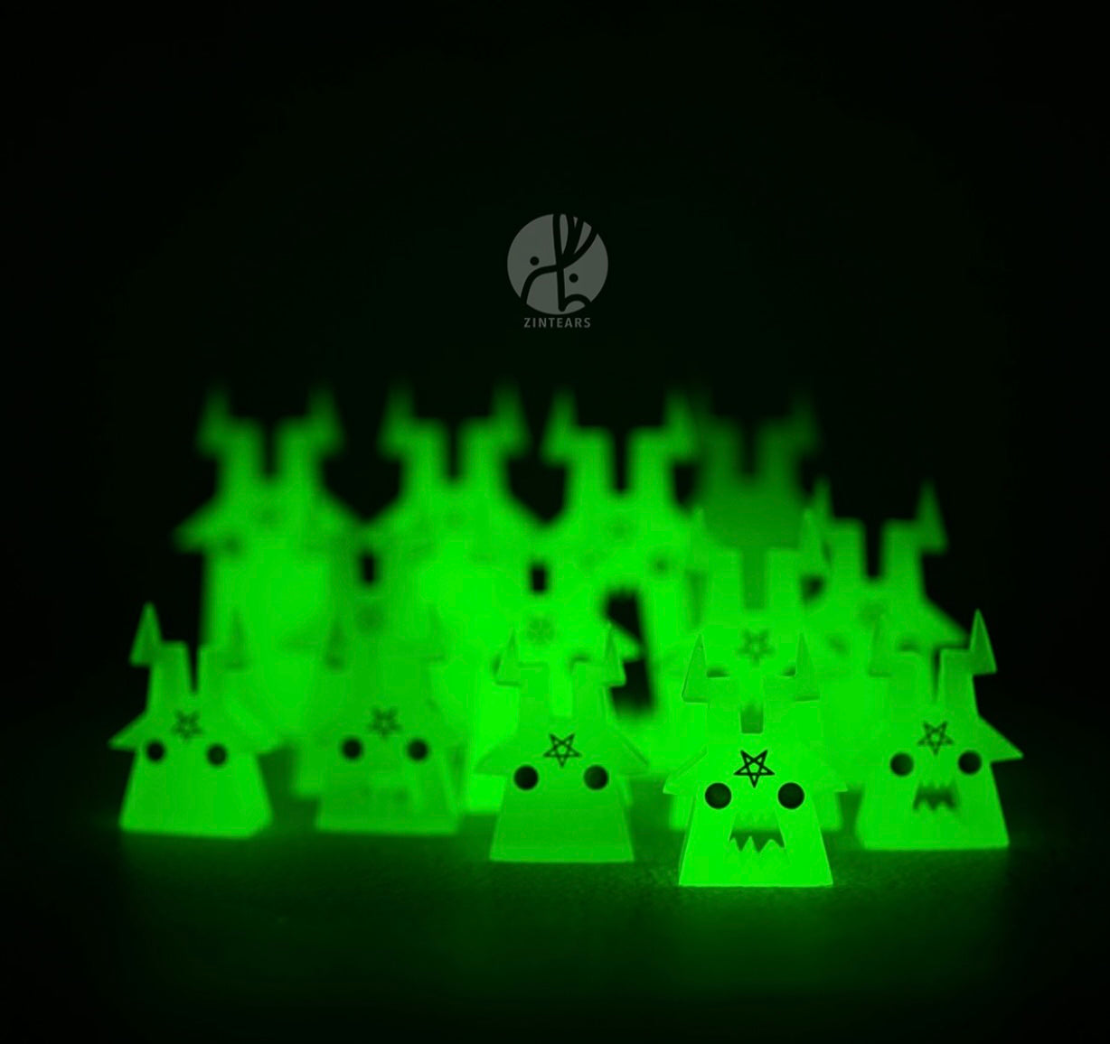 Phillips blind bag by Zintears: Neon green, glow-in-the-dark acrylic meeples shaped like horned creatures with star foreheads, serving as decorative gaming tokens.
